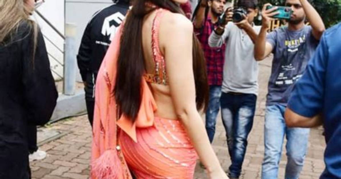 Not Nora Fatehi's Ruffled Saree but Her Micro Purse and 80S Hairstyle Make a Style Statement